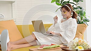 Beautiful Asian woman doing spa at home and also working.