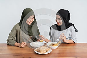 Woman enjoy ketupat and opor ayam photo