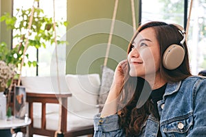 A beautiful asian woman enjoy listening to music with headphone