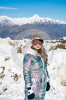 Beautiful asian woman enjoying and relaxing view with snow flake on snow mountain during winter in New Zealand