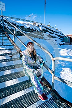 Beautiful asian woman enjoying and relaxing view with snow flake on snow mountain during winter in New Zealand