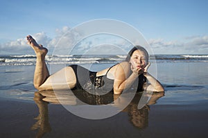 Beautiful Asian woman enjoying sand and sea - young happy and attractive Korean girl in bikini having fun at tropical beach during