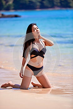 Beautiful asian woman enjoying on a tropical beach