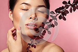 Beautiful Asian Woman with Fresh Daily Makeup. Beauty Girl with Spring Gloss Make-up on Pink Background