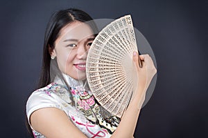 Beautiful Asian woman with a hand fan