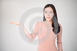 Beautiful asian woman with happy smile showing or presenting pro