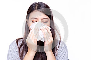Beautiful asian woman has a cold or flu. She feel sick and dizzy. Pretty girl blowing nose by using tissue paper. She has nasal
