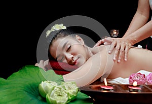 beautiful Asian woman having massage in spa environment.