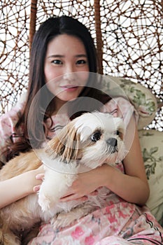 Beautiful Asian woman holding a dog