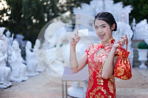 Beautiful asian woman holding dollars or money with lucky pocket money,in the Chinese New Year. Festivities, New Year Celebration