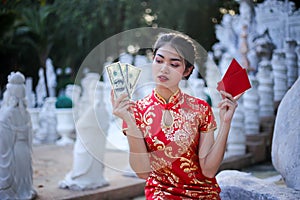 Beautiful asian woman holding dollars or money with lucky pocket money,in the Chinese New Year. Festivities, New Year Celebration