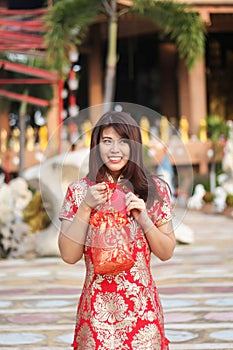 Beautiful asian woman holding dollars or money with lucky pocket money,in the Chinese New Year. Festivities, New Year Celebration