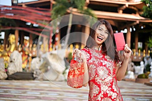 Beautiful asian woman holding dollars or money with lucky pocket money,in the Chinese New Year. Festivities, New Year Celebration