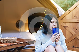 Beautiful asian woman holding and drinking a cup of coffee in the morning,Enjoys of resting time