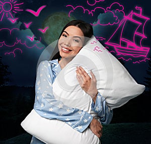 Beautiful Asian woman holding pillow dreaming about voyage, night sky with full moon on background