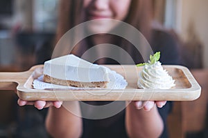 A beautiful Asian woman holding and showing yogurt cheese pie with feeling happy and good lifestyle