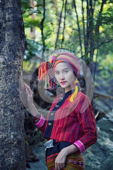 Beautiful Asian woman with karen traditional dress explore in forest during her summer vacation in thailand, Asia