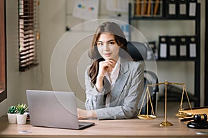 Beautiful asian woman lawyer working and gavel, tablet, laptop in front, Advice justice and law concept