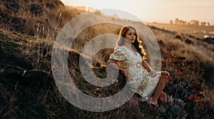 Beautiful asian woman  looking at view in field with sunset at New zealand countryside near the outskirts of Christchurch