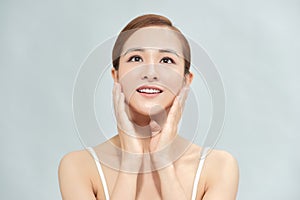 Beautiful asian woman with perfect makeup and smooth skin isolated on color background. Facial Beauty plastic surgery concept