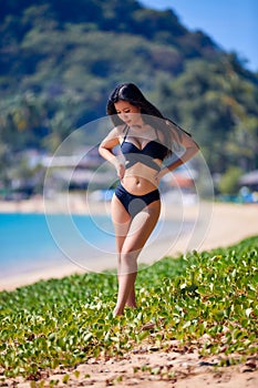 Beautiful asian woman posing on a tropical beach