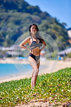 Beautiful asian woman posing on a tropical beach