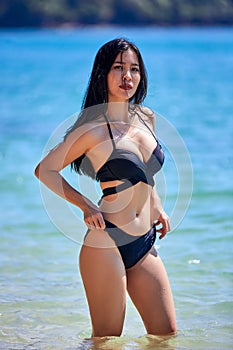 Beautiful asian woman posing on a tropical beach