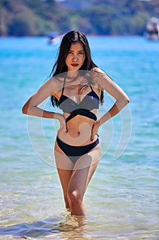Beautiful asian woman posing on a tropical beach