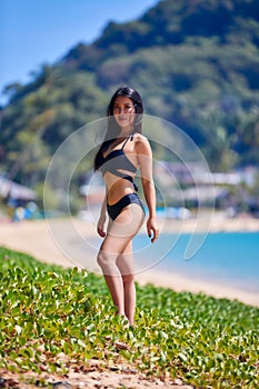 Beautiful asian woman posing on a tropical beach