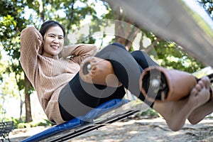 Beautiful asian woman practicing fitness,doing sit up exercise for health at city park,happy smiling female people doing abdominal
