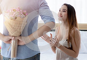 Beautiful Asian woman received flowers from a young man. Women are very happy when they receive flowers. Love day festival