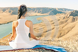 Beautiful asian woman relaxing and meditating outdoor at mountai