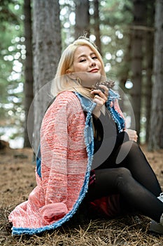 Beautiful asian woman relaxing in the middle of a pine forest