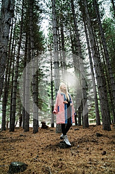 Beautiful asian woman relaxing in the middle of a pine forest