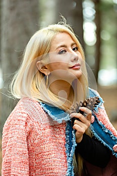 Beautiful asian woman relaxing in the middle of a pine forest