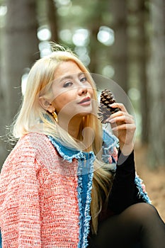 Beautiful asian woman relaxing in the middle of a pine forest