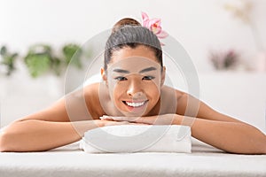 Beautiful Asian Woman Relaxing In Spa Salon, Lying On Massage Table