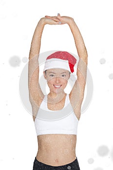 Beautiful asian woman in Santa`s hat engaged in fitness