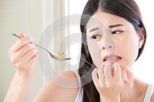 beautiful asian woman scared to eat too much nutritional supplement