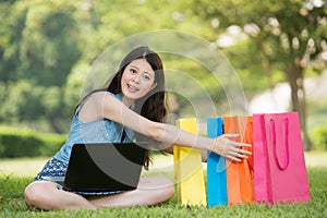 Beautiful asian woman shopping online holding gift