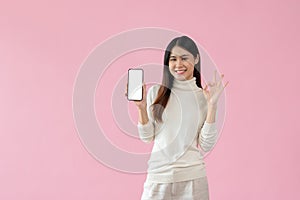 A beautiful Asian woman is showing the Okay hand sign and a smartphone mockup to the camera