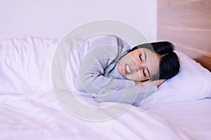 Beautiful asian woman sleeping on bed and grinding teeth,Female tiredness and stress