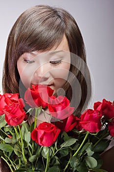 Beautiful asian woman smelling flowers