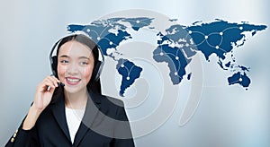 Beautiful asian woman smiling customer service talking on headset with world map communication.