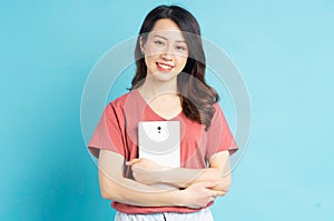 Beautiful asian woman smiling holding tablet computer