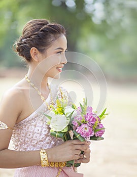 Beautiful asian woman toothy smiling face and pink lotus flower