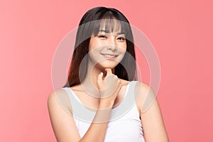 Beautiful Asian woman touching soft cheek smile with clean and fresh skin