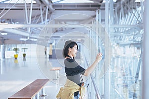 Beautiful Asian woman traveler using mobile phone in airport, Lifestyle using cell phone