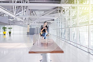 Beautiful Asian woman traveler using mobile phone in airport, Lifestyle using cell phone