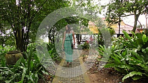 Beautiful Asian Woman Traveler Walking Along the path in the Jungle